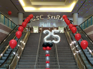 SHRM conference balloon entrance hall decorations convention center with arch, column, and railing decor