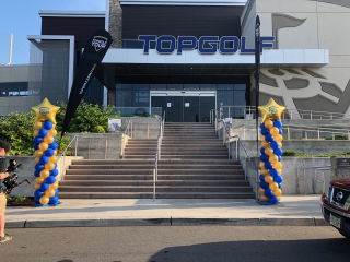 Balloon columns at Top Golf for tour event outdoor spiral with personalized custom balloons