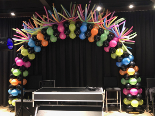 New Years Eve balloon arch with fireworks neon colors Top Golf