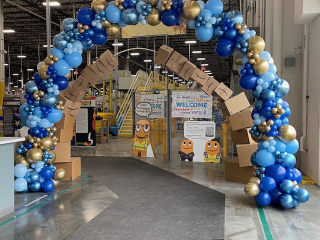 Free form organic balloon arch in Amazon warehouse celebrating 3 year anniversary and peak season