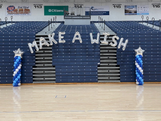 Make a Wish Foundation balloon arch at gymnastics event in gym